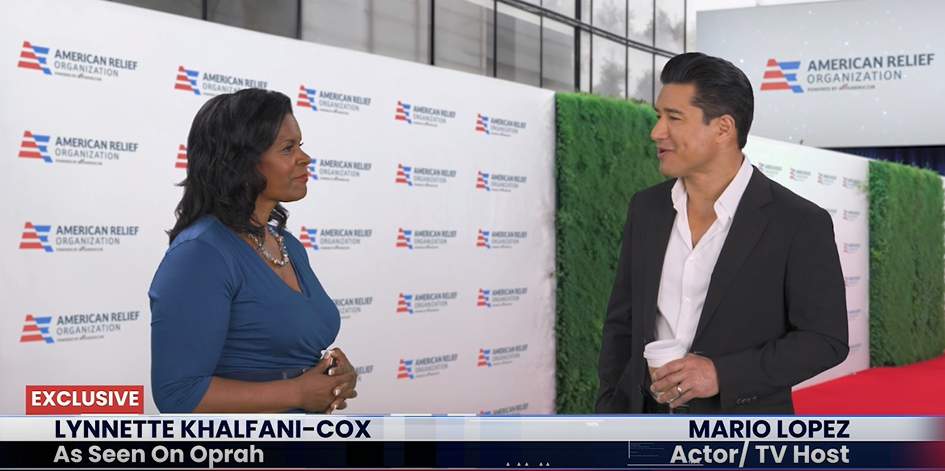 Photo of Lynnette Khalfani-Cox and Mario Lopez talking to each other